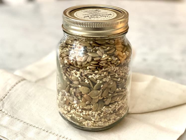 A jar of mixed seeds for healthy snacking.