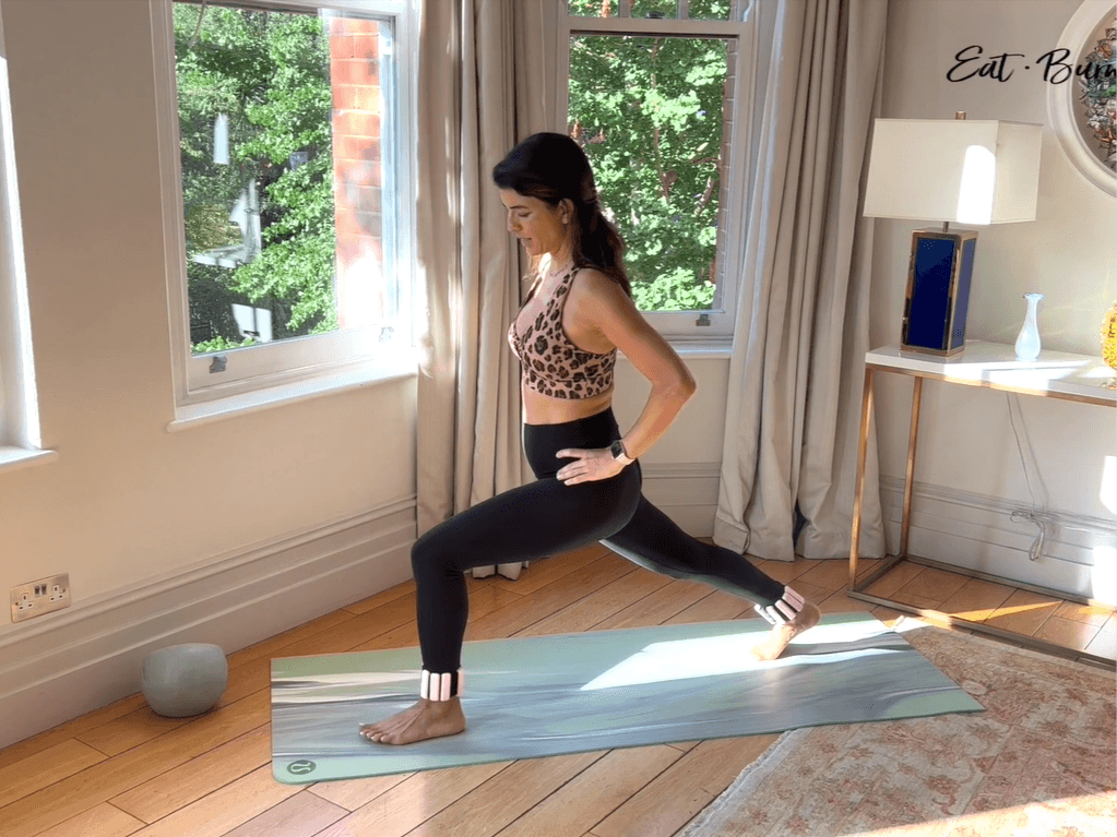 Yalda Alaoui screenshot of her mid-exercise on a green exercise mat with a ball close by.
